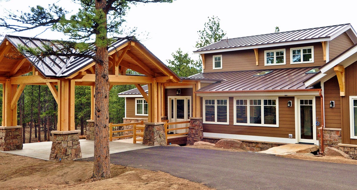 Exterior of a home with a new metal roof and a covered patio area