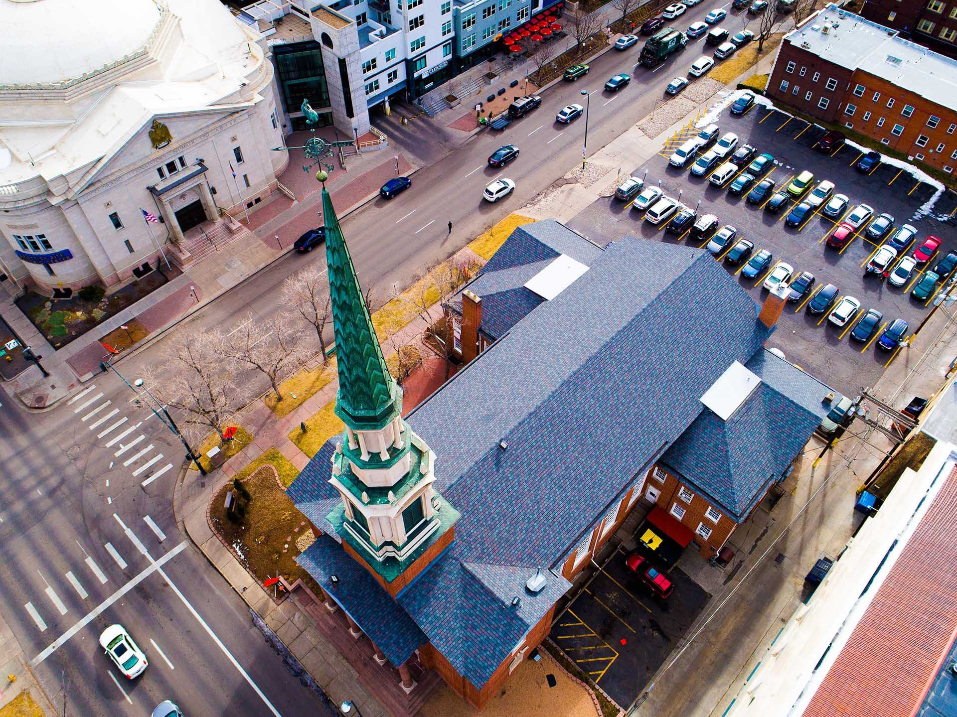 Aerial view of asphalt roofing completed on church in downtown Denver