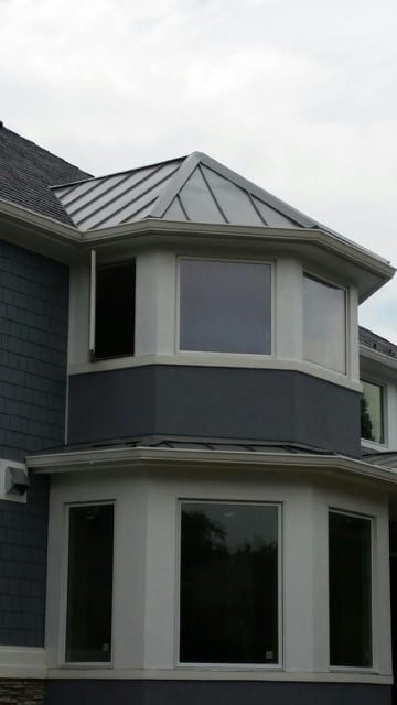 Seamless gutters on exterior of circular room