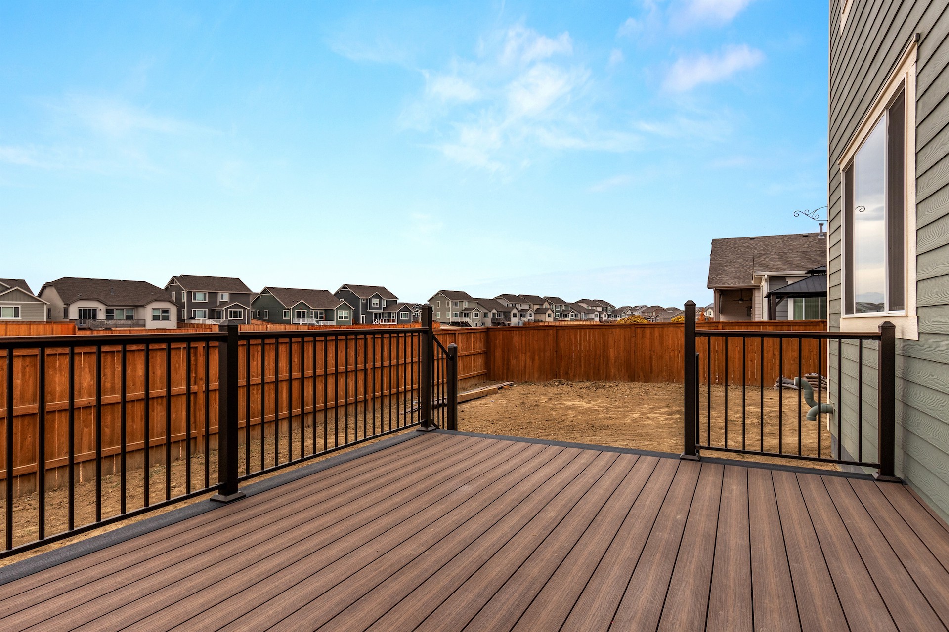 Large wooden deck with dark brown railing