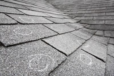 Old roof with hail damage, chalk circles mark the damage