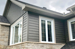 House with grey metal siding installed by Northern Lights Exteriors