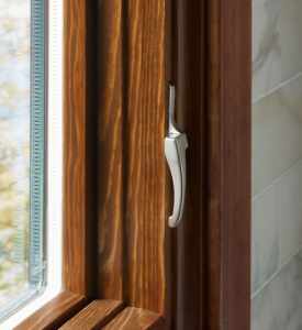 Closeup of a wood-framed casement window handle