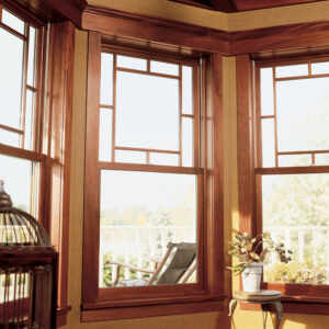 Large, wood windows with sunlight coming through them