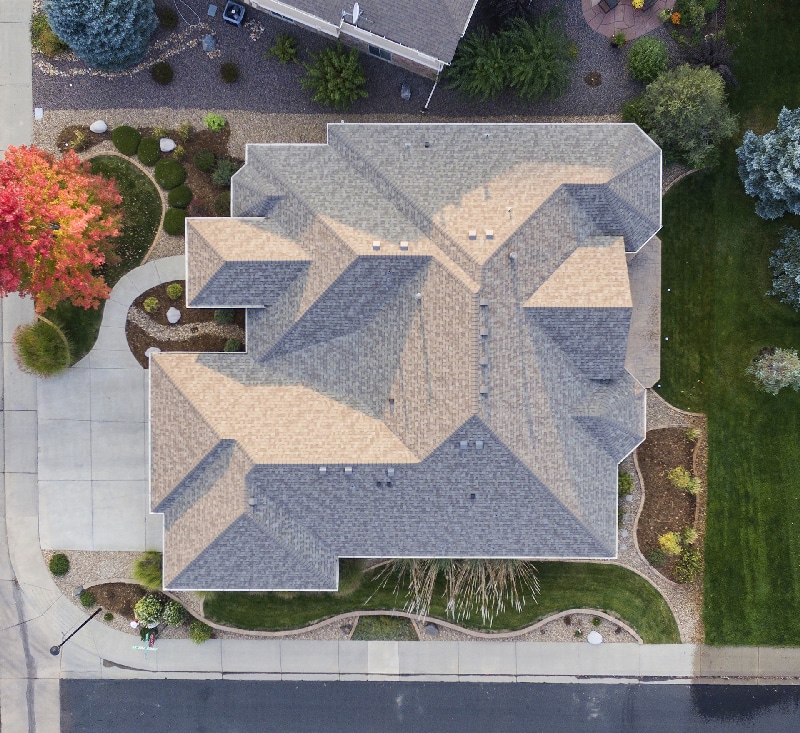 Top view of a large home with a newly installed beige architectural shingle roof
