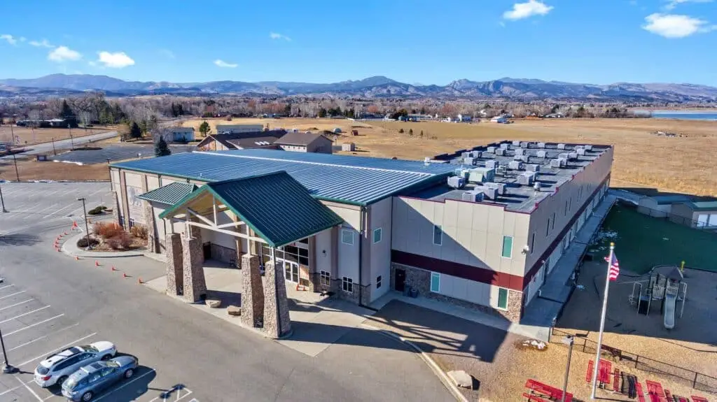 Aerial view of a school building in Loveland, Colorado clad in James Hardie siding with new exterior paint