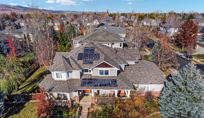 Beautiful gray architectural asphalt shingle roof on a two-story home with solar panels