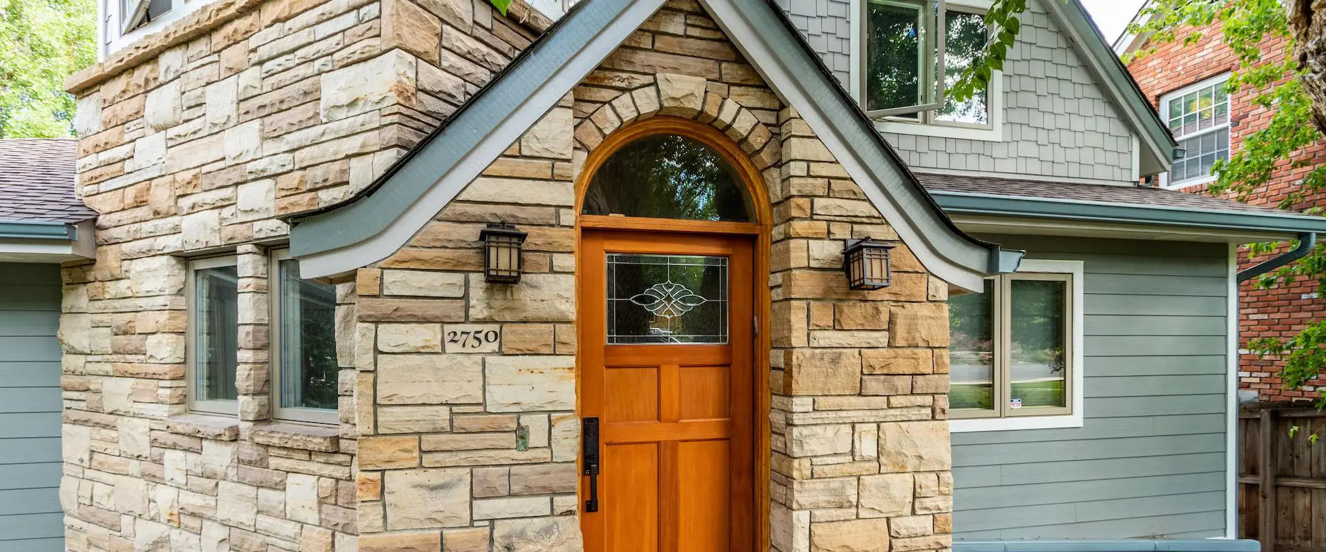 home with stone house siding | Northern Lights Exteriors