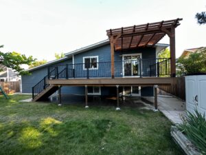Deck and pergola project in Lafayette, CO featuring a low-maintenance composite deck with modern railing and a custom wood pergola for shade and style.