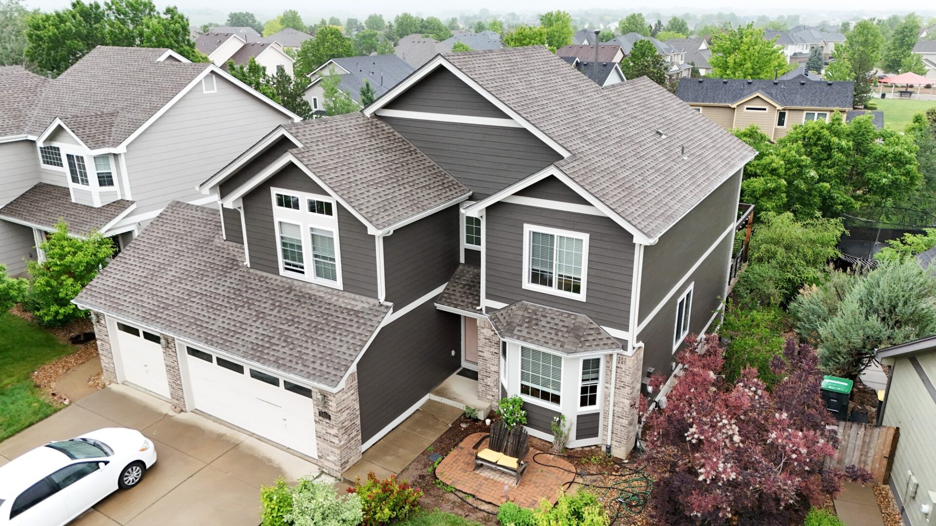 Longmont Colorado home featuring James Hardie Rich Espresso siding with Cobblestone trim installed by Northern Lights Exteriors
