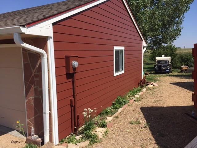 Johnstown exterior remodeling project featuring James Hardie Country Lane Red siding with Arctic White trim.