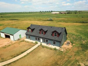 Fort Lupton project with James Hardie Evening Blue lap siding, Countrylane Red gable accents and Iron Gray trim