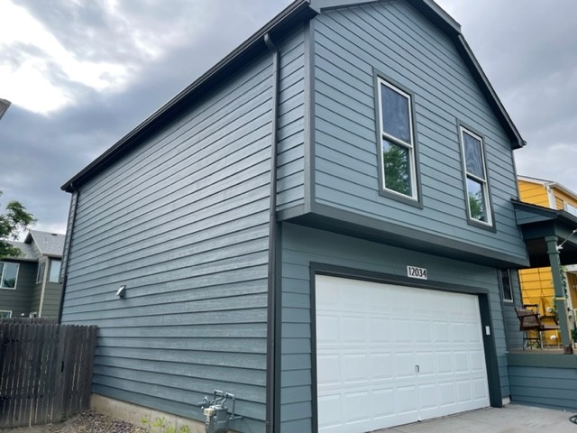 Brighton home with James Hardie Boothbay Blue siding and Iron Gray trim installed by Northern Lights Exteriors