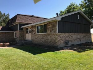 Brighton, CO home with James Hardie Rich Espresso siding and Cobblestone trim by Northern Lights Exteriors.