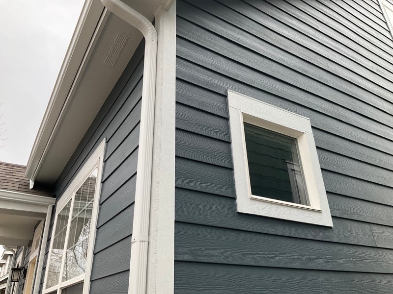 Close-up of James Hardie Iron Gray lap siding with Arctic White trim installed by Northern Lights Exteriors
