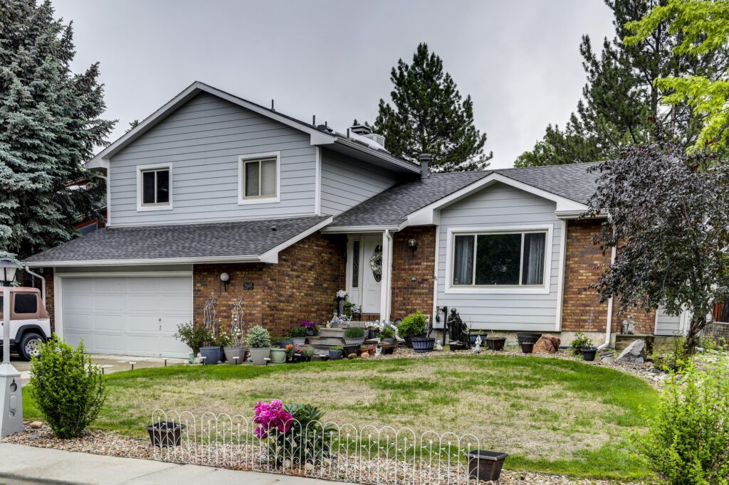 Home near Erie featuring James Hardie Light Mist siding with Arctic White trim installed by Northern Lights Exteriors
