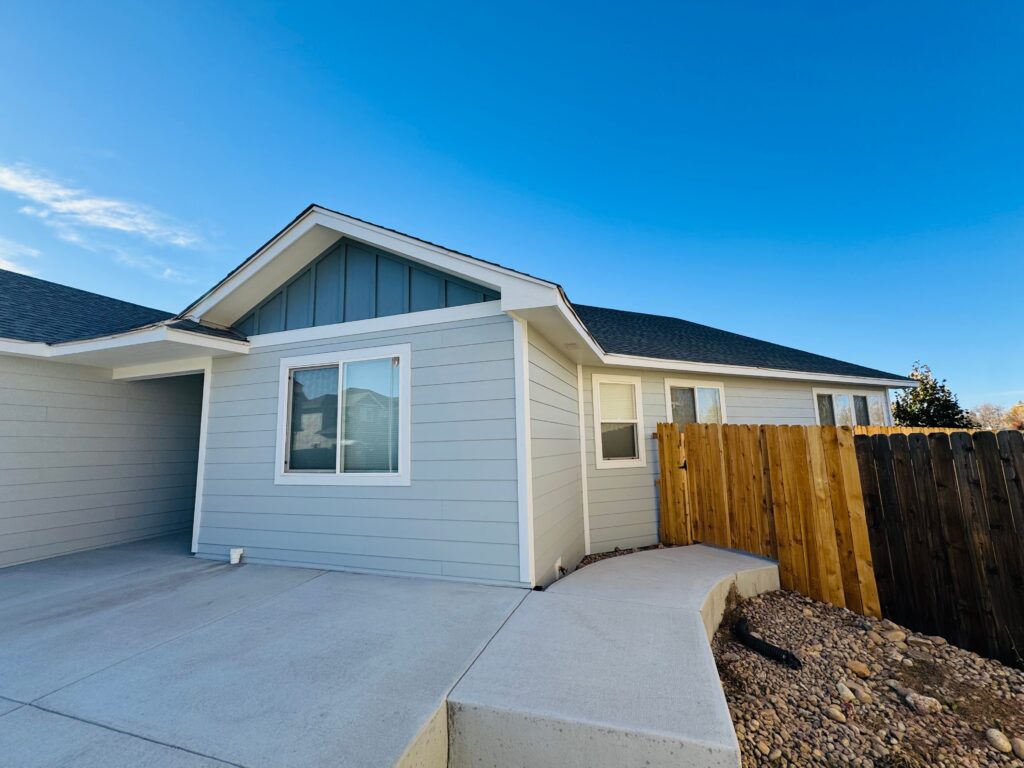 Frederick, Colorado home in James Hardie Light Mist lap siding with a Boothbay Blue board-and-batten gable accent.
