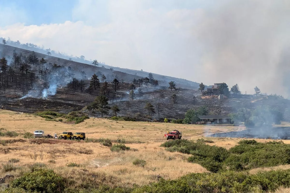 Stone Canyon Fire flames near a Lyons, CO property with James Hardie siding and fire-resistant exterior components.