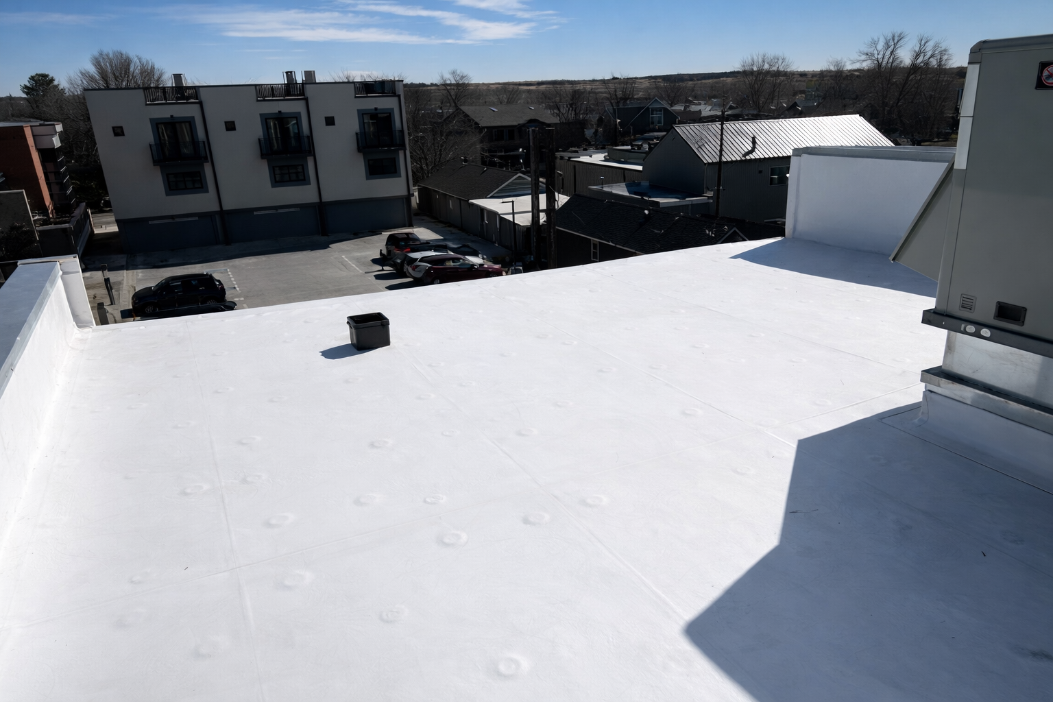 White EPDM roofing installed as part of a multi-trade exterior remodel in Louisville Colorado
