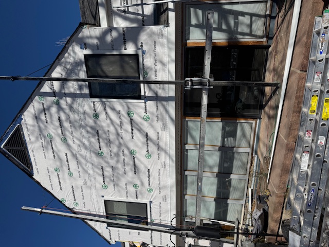 House siding elevation with broader damage requiring replacement planning in Colorado