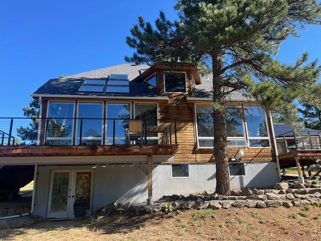 Rear elevation of a Boulder CO mountain home before James Hardie Woodtone fire-rated siding by Northern Lights Exteriors