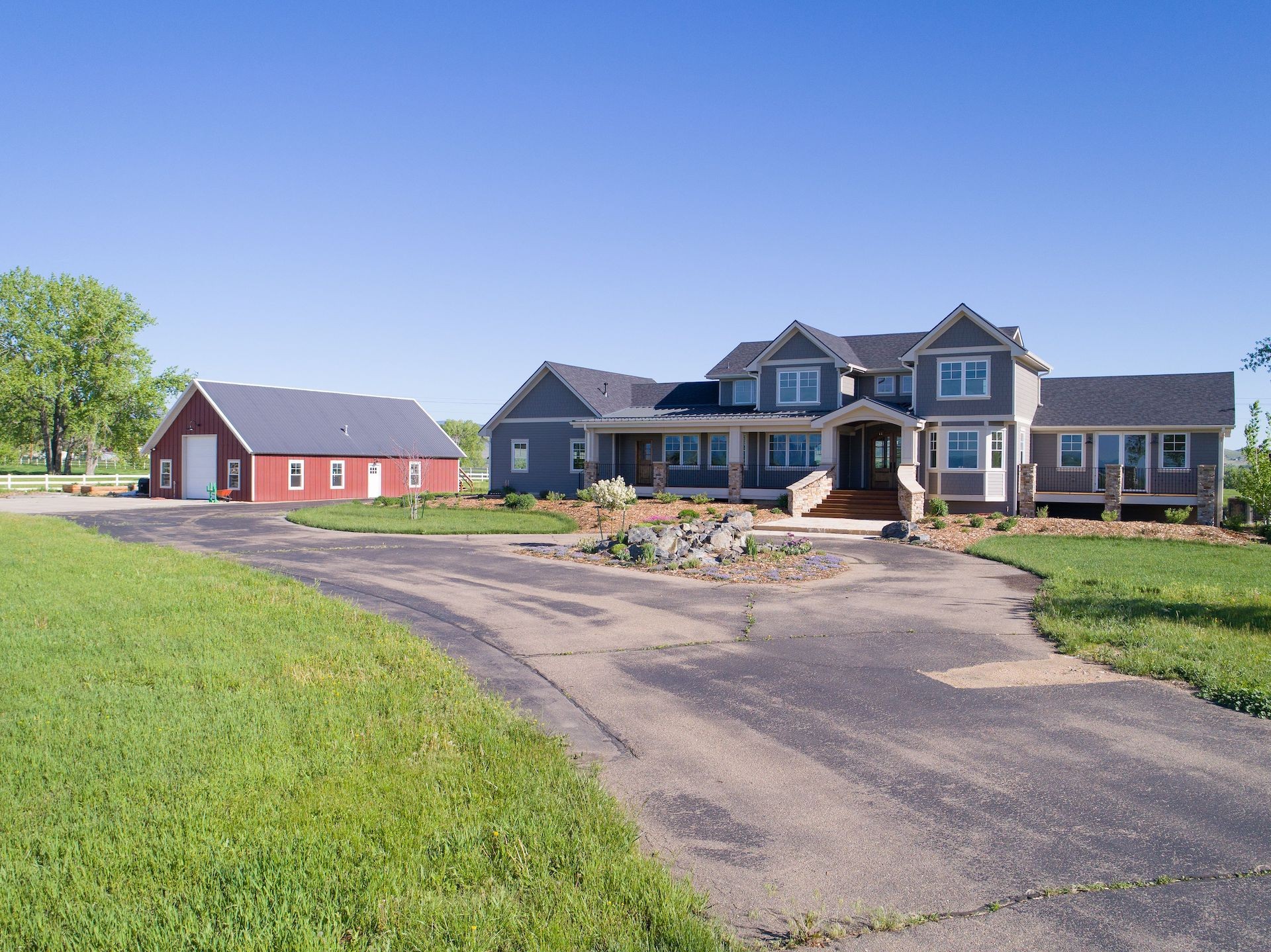 Longmont CO home with James Hardie Aged Pewter lap siding and red barn rural property setting