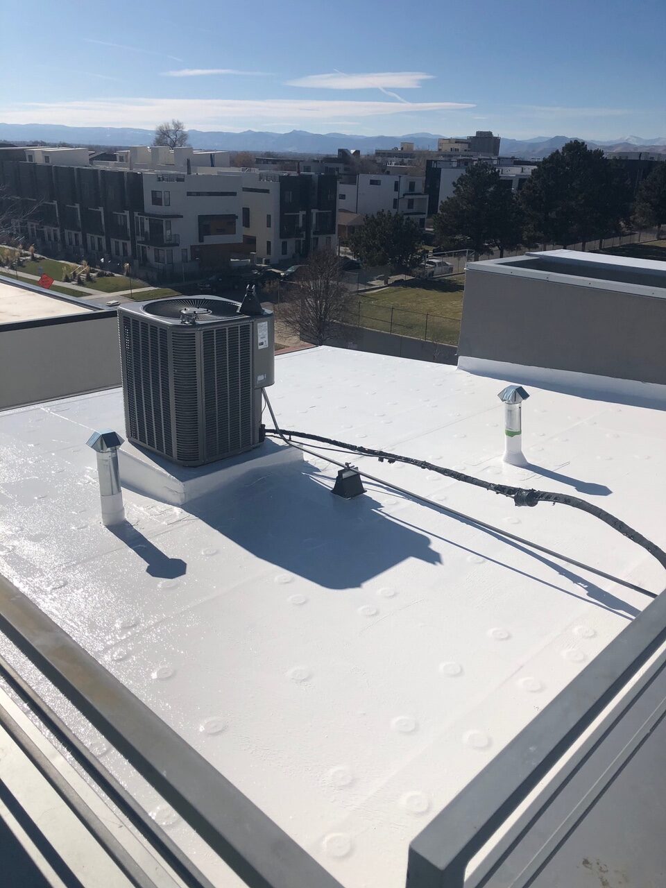 Roof coating on Denver condo commercial exterior remodel by Northern Lights Exteriors