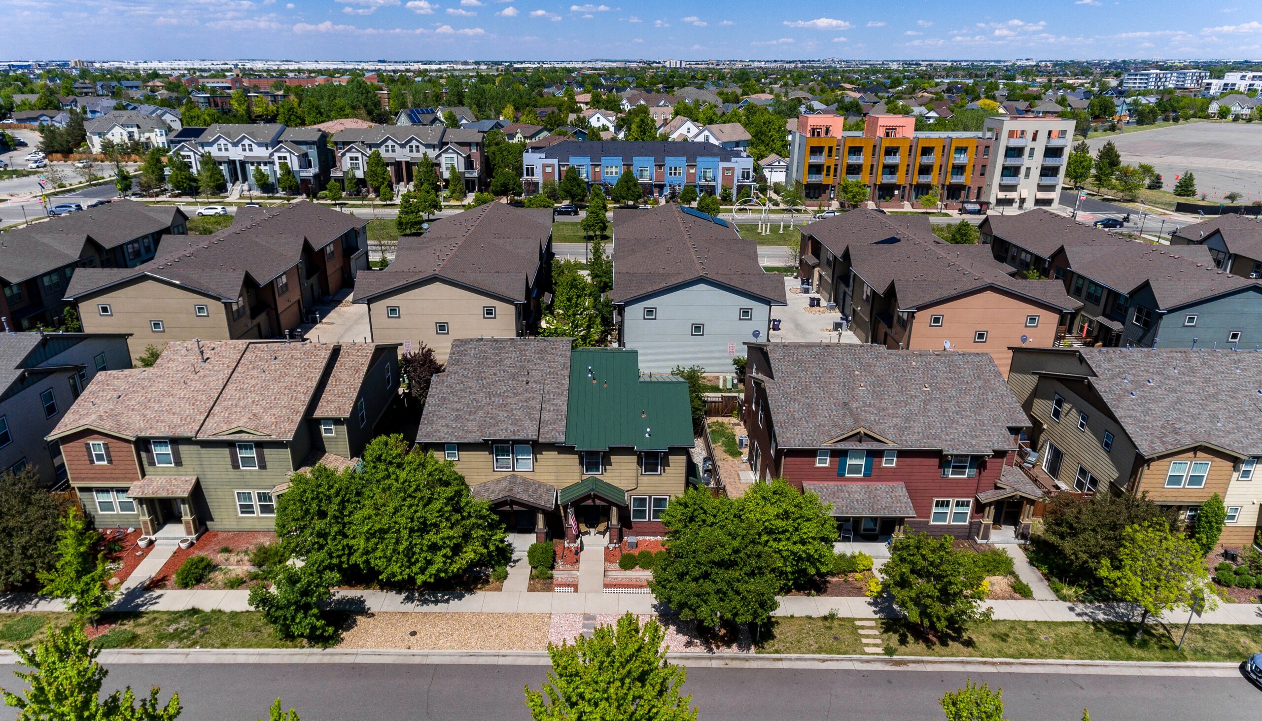 Aerial drone view of a duplex in Denver, Colorado featuring a custom standing seam metal roof installed by Northern Lights Exteriors, showcasing modern metal roofing, durable weather protection, and enhanced urban curb appeal.