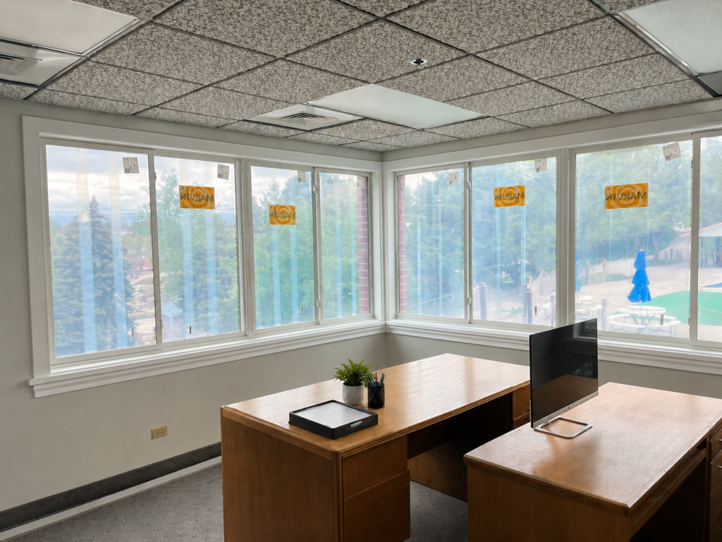 Commercial office interior with newly installed Marvin fiberglass windows along two walls