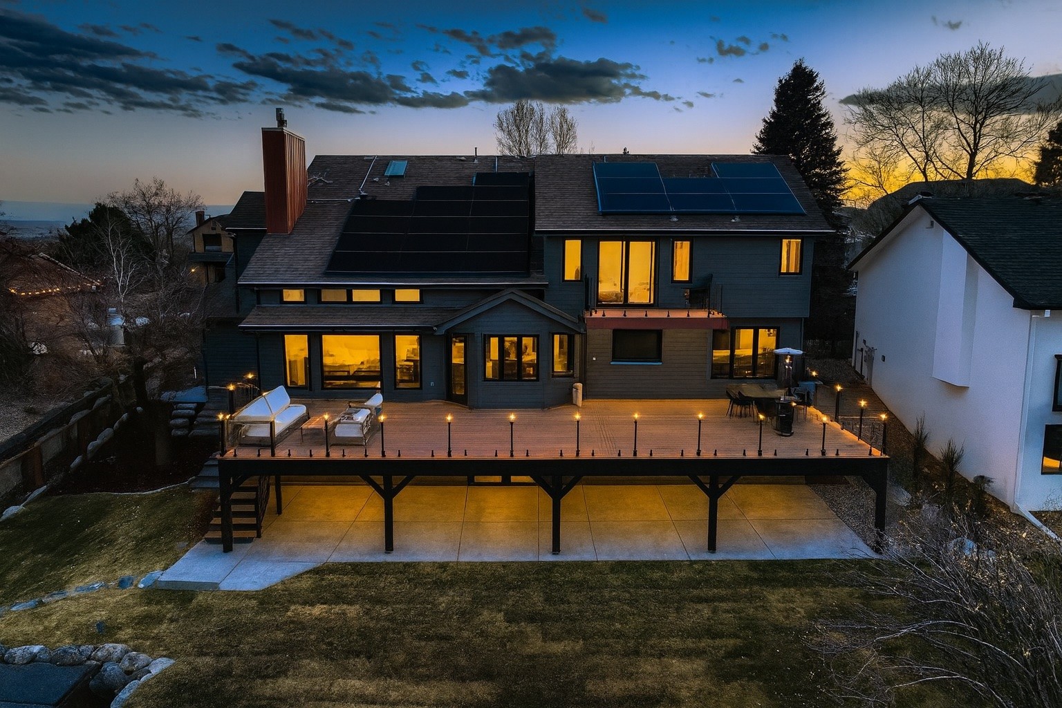 Class-A fire rated deck in Louisville, Colorado featuring a steel-framed deck structure, premium composite decking, frameless glass railing system, integrated deck lighting, and expansive outdoor living space designed to maximize mountain views while providing exceptional durability, fire resistance, and low-maintenance performance.