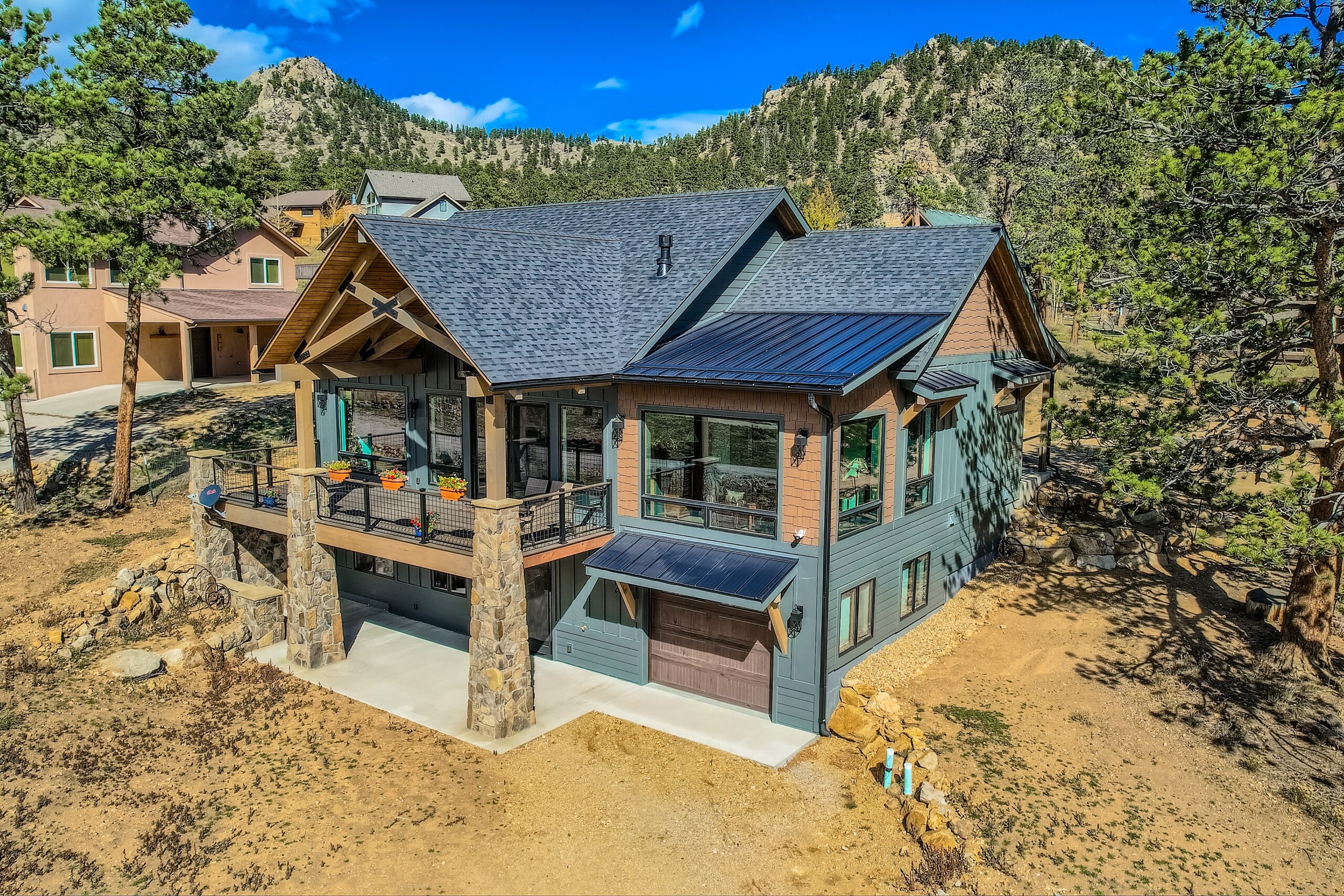 James Hardie Dream Collection Iron Gray fiber cement siding with Woodtone accents installed on an Estes Park, CO mountain home featuring Class A fire-rated exterior protection.