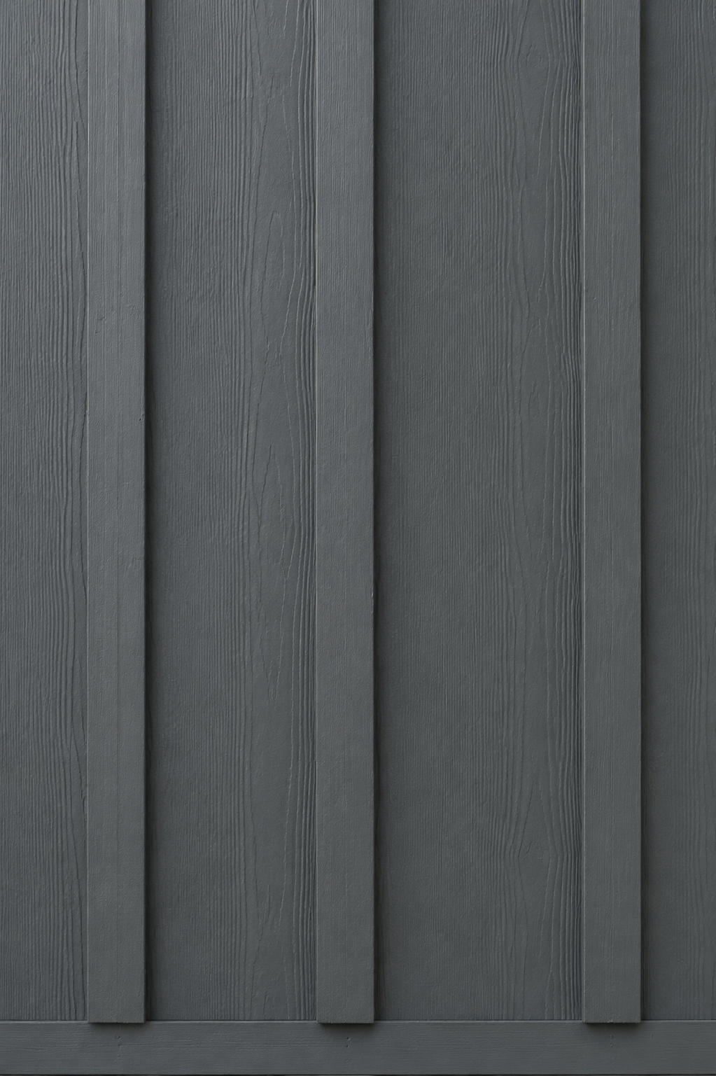 Close-up of James Hardie board and batten vertical siding showing HardieTrim batten spacing, cedar-grain texture, and ColorPlus factory finish