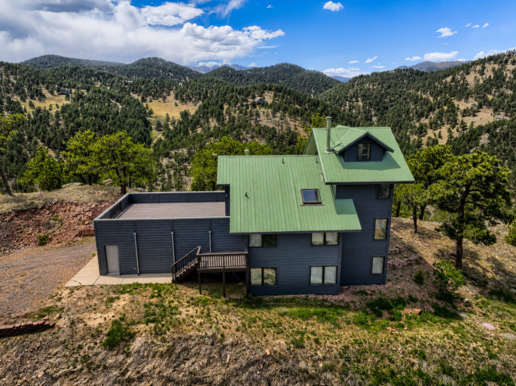 Mountain home near Boulder, CO with a metal roof and James Hardie Iron Gray siding by Northern Lights Exteriors
