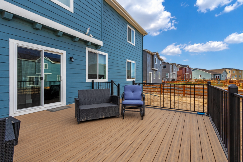 Composite deck with wood-look decking and black metal railing in Erie, CO by Northern Lights Exteriors