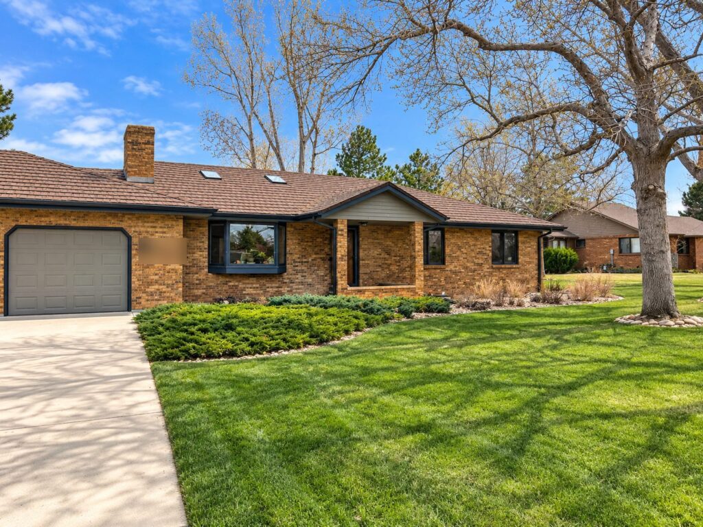 Firestone, Colorado brick ranch with new black-frame replacement windows including a bay window, installed by Northern Lights Exteriors