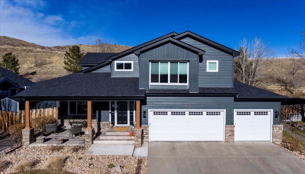 Multi-trade exterior remodel in Golden, Colorado by Northern Lights Exteriors — Class IV impact-resistant asphalt roofing, James Hardie fiber cement lap and board-and-batten siding, new windows and seamless gutters, below the hogback